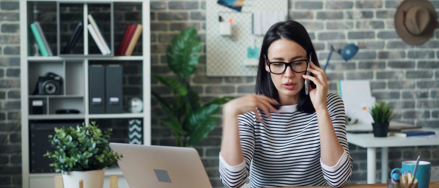 A millennial woman on the phone with a divorce mediator.