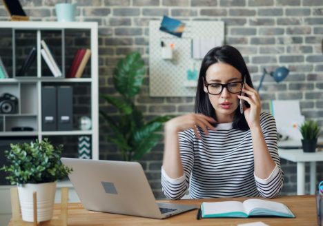 A millennial woman on the phone with a divorce mediator.